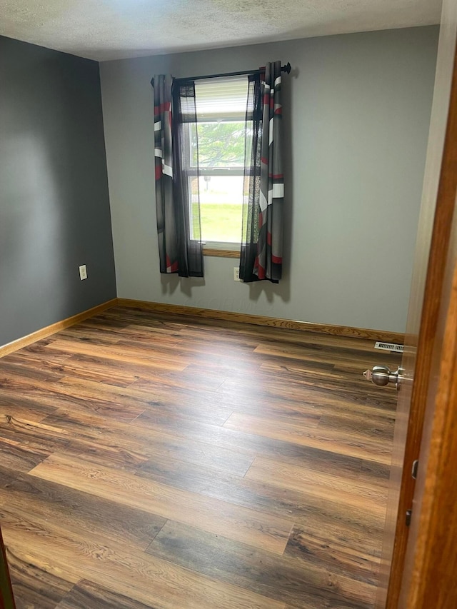 10519 Darby Creek Rd, Orient, OH 43146 - unfurnished room with wood finished floors and a textured ceiling