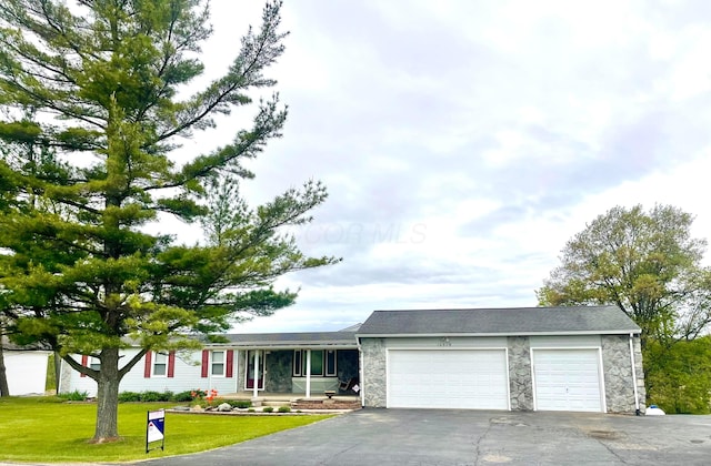 10519 Darby Creek Rd, Orient, OH 43146 - single story home featuring an attached garage, stone siding, asphalt driveway, a front lawn, and covered porch