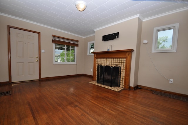 unfurnished living room featuring crown molding, wood finished floors, and visible vents