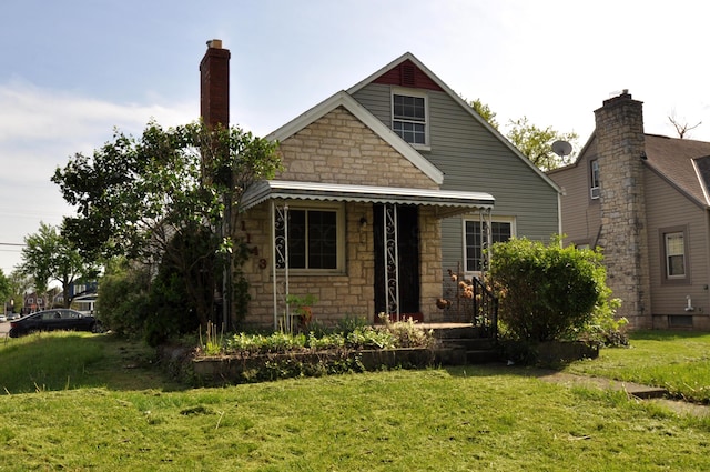view of front of property featuring a front lawn and stone siding
