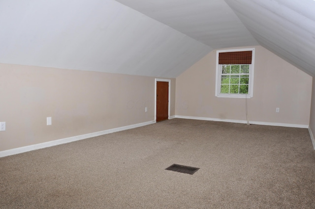 bonus room with vaulted ceiling, baseboards, carpet flooring, and visible vents