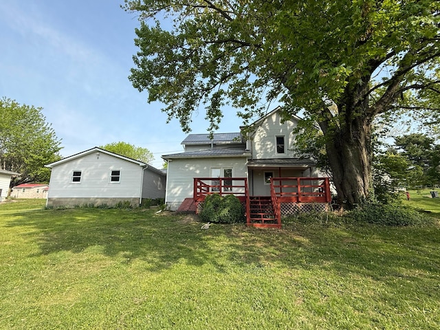 back of property featuring a yard and a deck