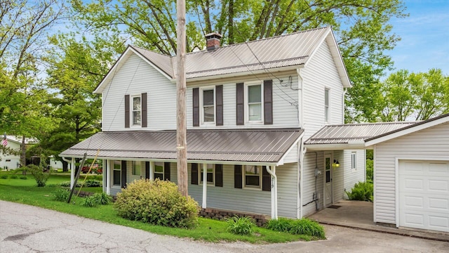 219 W Sheridan Ave, Somerset, OH 43783 - view of front of home with a porch, a chimney, metal roof, and driveway