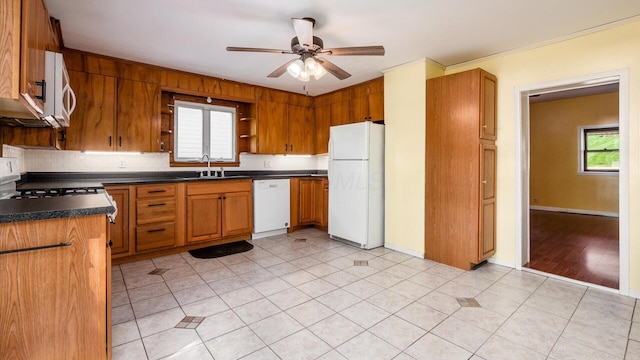 219 W Sheridan Ave, Somerset, OH 43783 - kitchen with white appliances, a sink, dark countertops, open shelves, and a ceiling fan