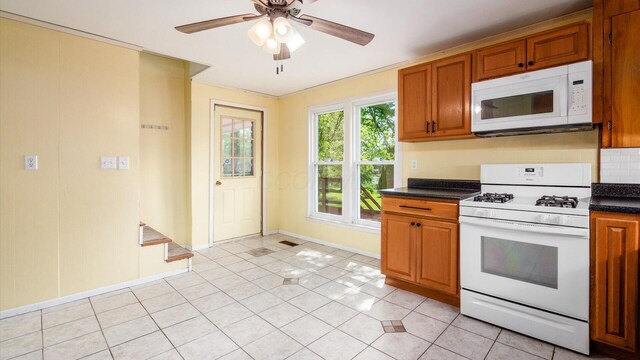 219 W Sheridan Ave, Somerset, OH 43783 - kitchen featuring white appliances, dark countertops, brown cabinets, and ceiling fan