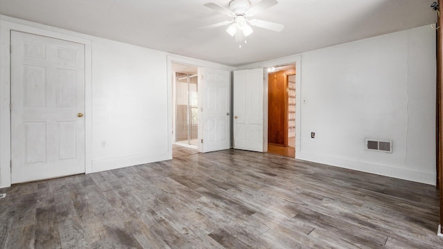 219 W Sheridan Ave, Somerset, OH 43783 - unfurnished bedroom with ensuite bath, wood finished floors, baseboards, and a ceiling fan
