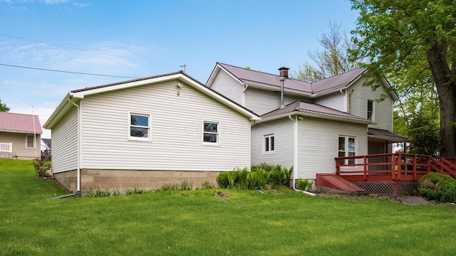 219 W Sheridan Ave, Somerset, OH 43783 - rear view of property featuring a wooden deck, a yard, and a chimney
