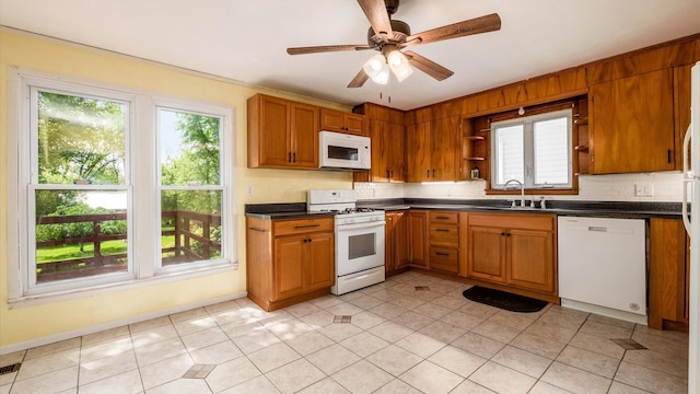 219 W Sheridan Ave, Somerset, OH 43783 - kitchen featuring white appliances, dark countertops, brown cabinetry, open shelves, and a sink