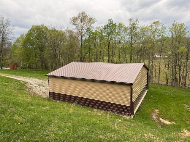 view of outbuilding with an outdoor structure and a forest view