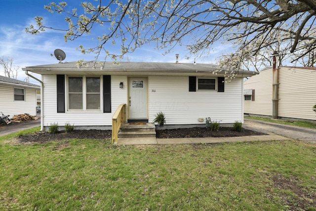 bungalow-style home featuring a front lawn