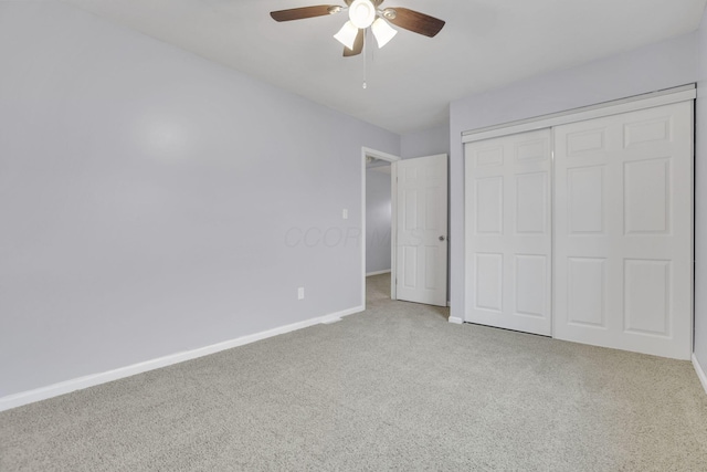 unfurnished bedroom featuring a closet, baseboards, ceiling fan, and carpet flooring