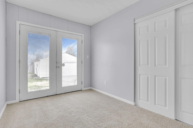 entryway featuring carpet floors, baseboards, and french doors