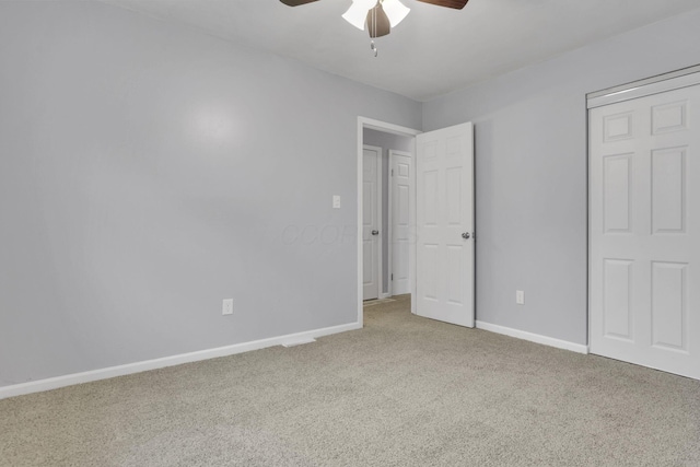 unfurnished bedroom featuring baseboards, ceiling fan, and carpet flooring