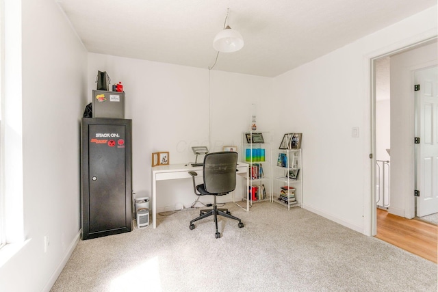 carpeted office space with baseboards