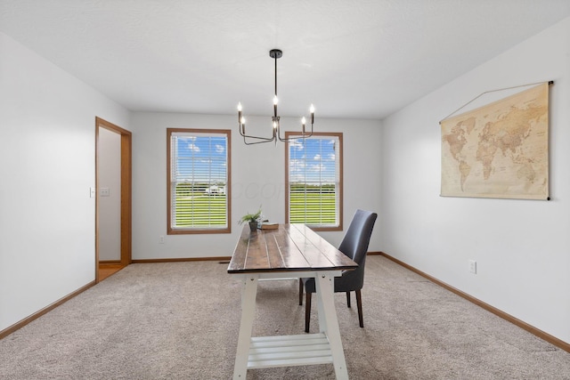 office area with a chandelier, baseboards, and carpet floors