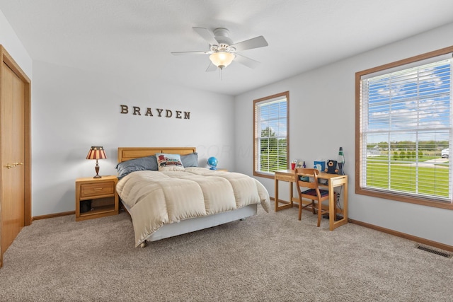 carpeted bedroom with baseboards, ceiling fan, and visible vents