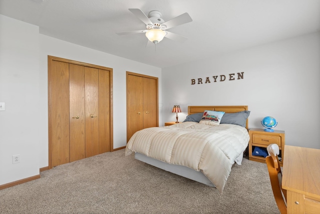 bedroom featuring a ceiling fan, carpet floors, baseboards, and multiple closets