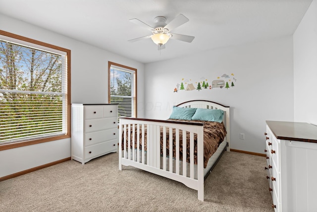 bedroom featuring baseboards, light carpet, and ceiling fan