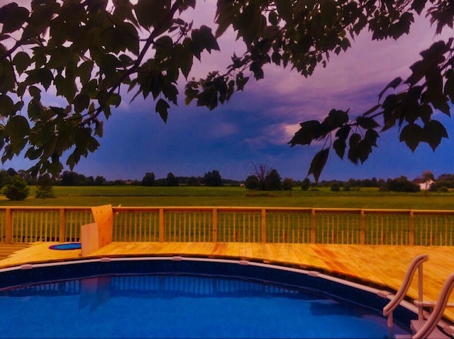 pool at dusk featuring a fenced in pool
