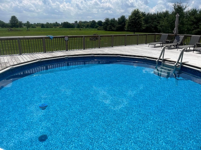 view of swimming pool featuring a wooden deck and a fenced in pool
