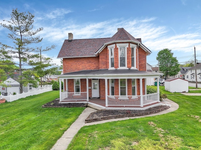 74 S Chester St, West Jefferson, OH 43162 - view of front of home with covered porch, a front lawn, and brick siding