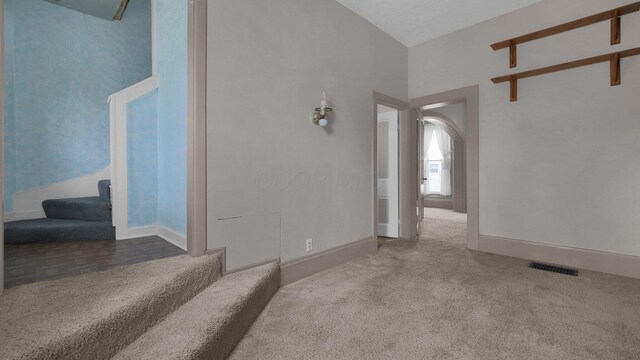 74 S Chester St, West Jefferson, OH 43162 - unfurnished living room featuring stairway, baseboards, carpet flooring, and visible vents