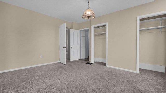74 S Chester St, West Jefferson, OH 43162 - unfurnished bedroom featuring two closets, baseboards, and carpet floors