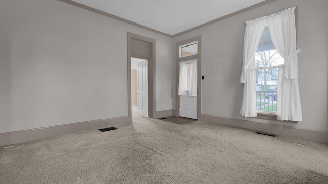 74 S Chester St, West Jefferson, OH 43162 - carpeted spare room featuring visible vents, ornamental molding, and a healthy amount of sunlight