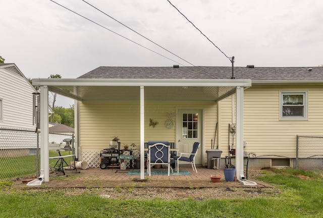 1234 E Fair Ave, Lancaster, OH 43130 - rear view of house featuring roof with shingles, fence, and a lawn