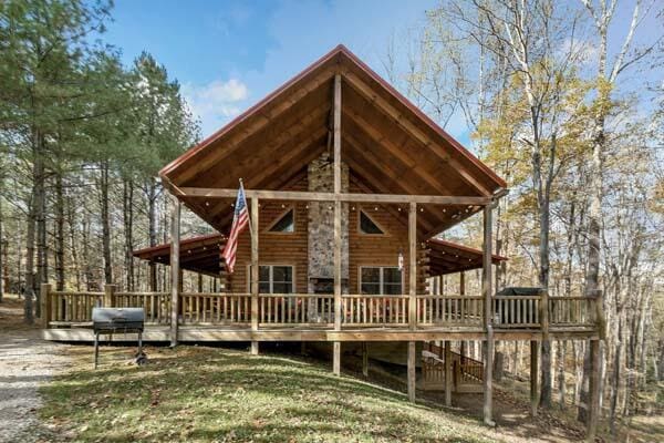 back of property with a lawn and a wooden deck