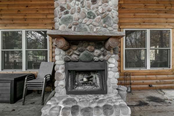 room details featuring rustic walls and a stone fireplace