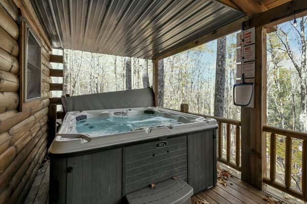 wooden terrace featuring a hot tub