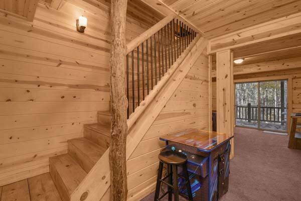 staircase featuring wooden walls and wood ceiling