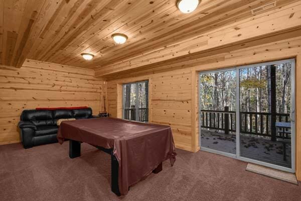 playroom with billiards, carpet, wood walls, and wooden ceiling