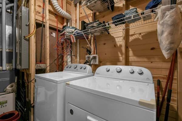 clothes washing area with washer and clothes dryer