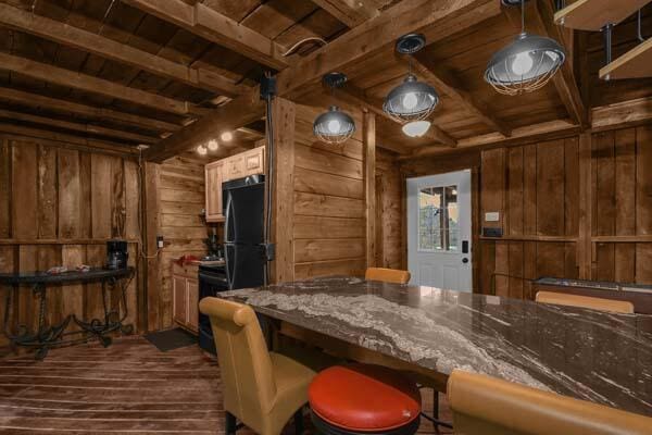 interior space featuring wooden walls, dark wood-style floors, wooden ceiling, and beam ceiling