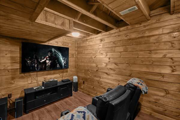 home theater featuring wood walls, visible vents, wood ceiling, and wood finished floors