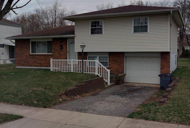 5208 Parkline Dr, Columbus, OH 43232 - split level home featuring an attached garage, a front yard, driveway, and brick siding