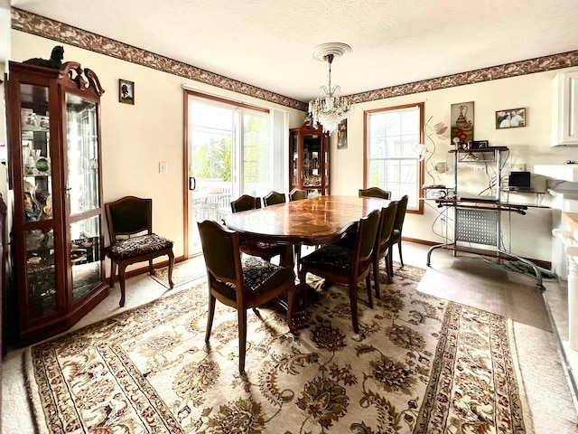 785 Lone Rise Dr E, Marysville, OH 43040 - dining room with baseboards, plenty of natural light, light colored carpet, and a chandelier