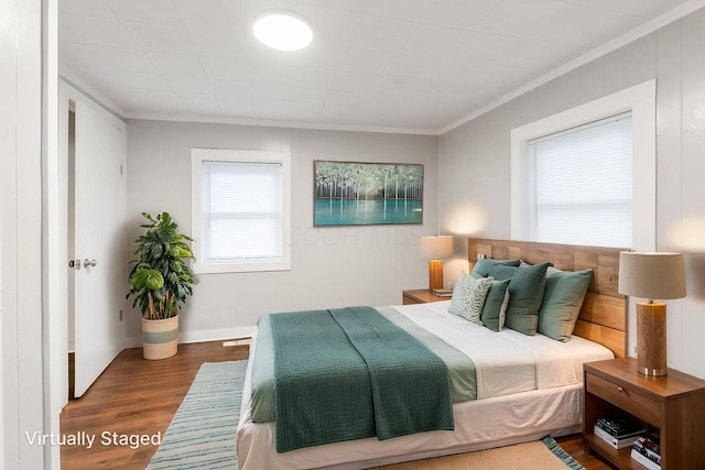 bedroom featuring crown molding and wood finished floors