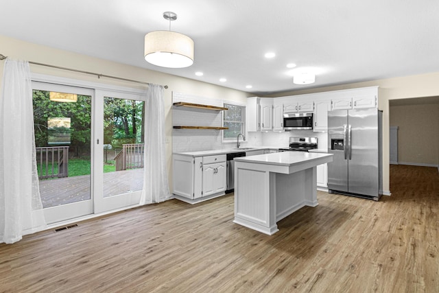 kitchen with visible vents, light countertops, white cabinetry, a sink, and appliances with stainless steel finishes