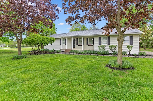 ranch-style home featuring a shingled roof, a porch, and a front lawn