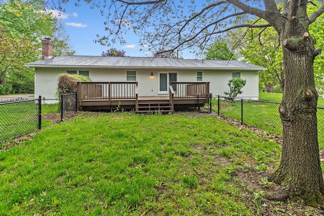 back of house with a fenced backyard, a chimney, a lawn, and a deck