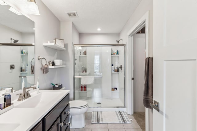 full bath featuring visible vents, a stall shower, toilet, and vanity