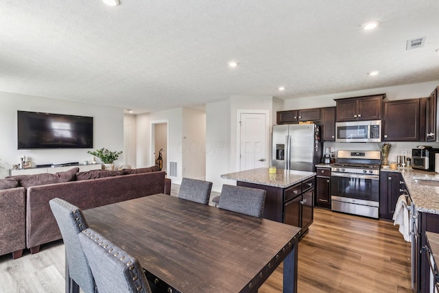 dining room with recessed lighting, visible vents, and light wood finished floors