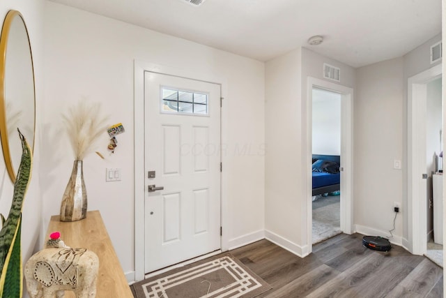 entryway featuring visible vents, dark wood-style flooring, and baseboards