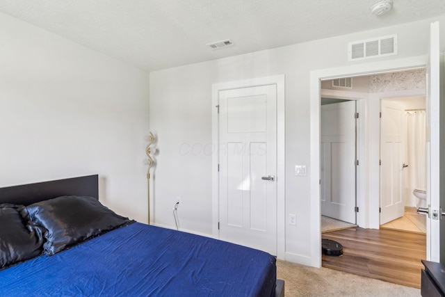 bedroom with visible vents and carpet flooring