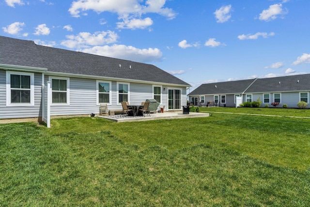back of property featuring a lawn and a patio area
