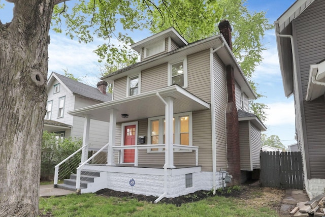 traditional style home with a porch and a chimney