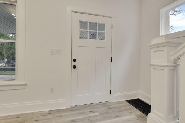 entryway featuring baseboards and light wood-style flooring